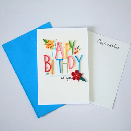 Colorful Happy Birthday quilled greeting card with raised lettering and paper flowers shown with envelope and message insert