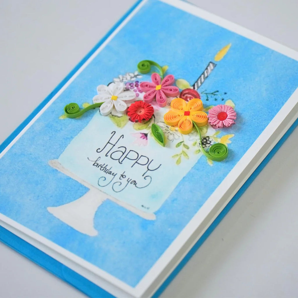 Side view showing raised paper flowers decorating a birthday cake illustration