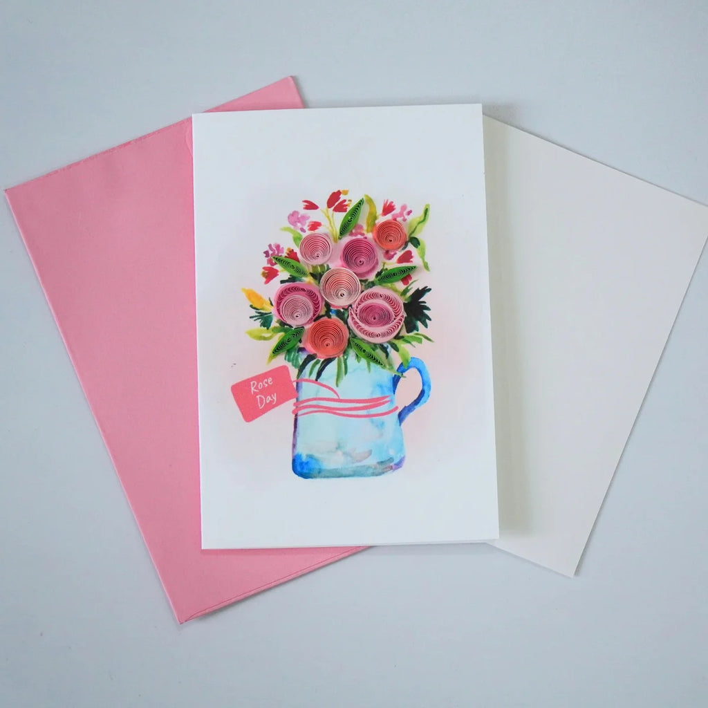 Rose Day quilled greeting card with pink paper roses in an illustrated blue jug shown with envelope and message insert