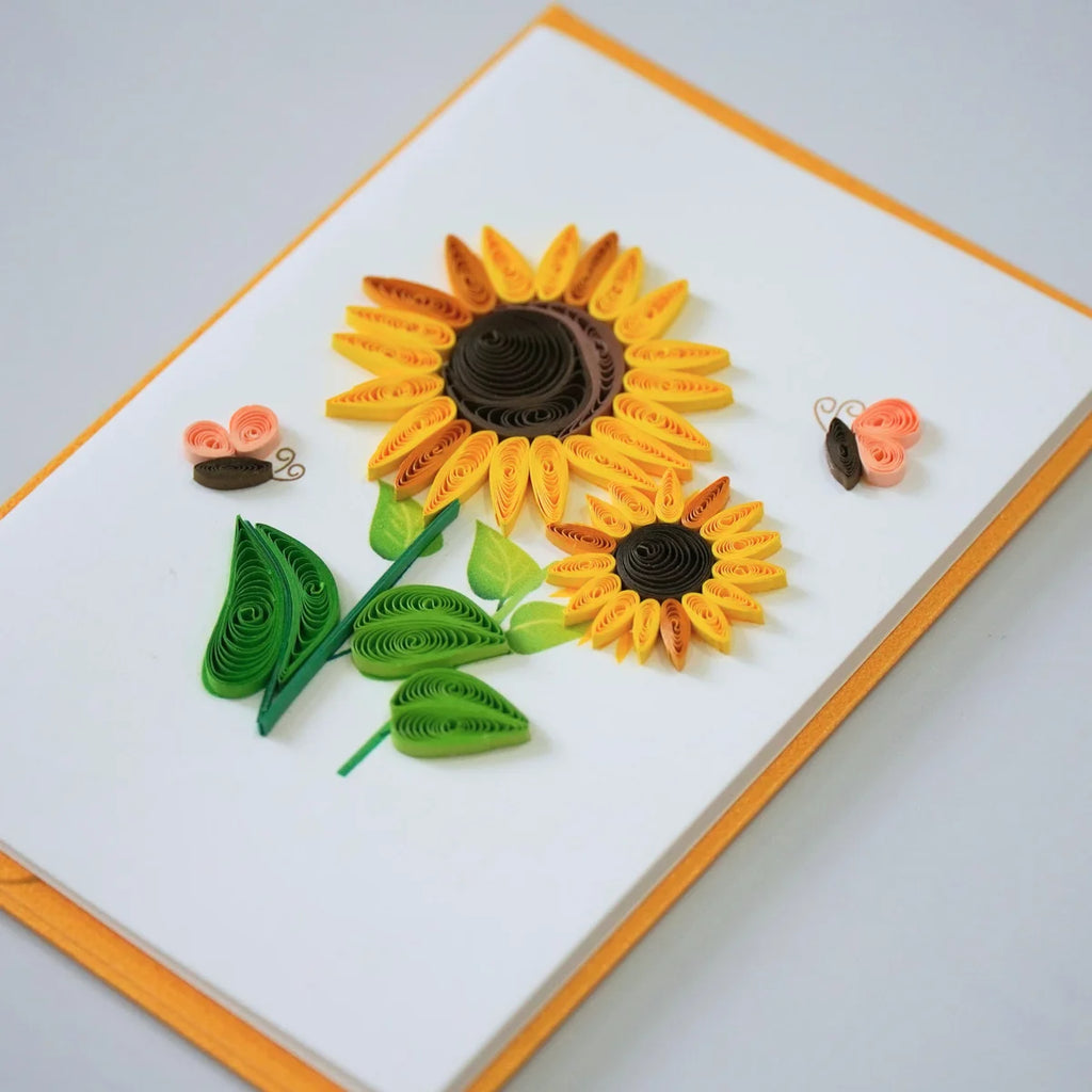Side view showing yellow and orange quilled sunflowers with butterflies and green leaves