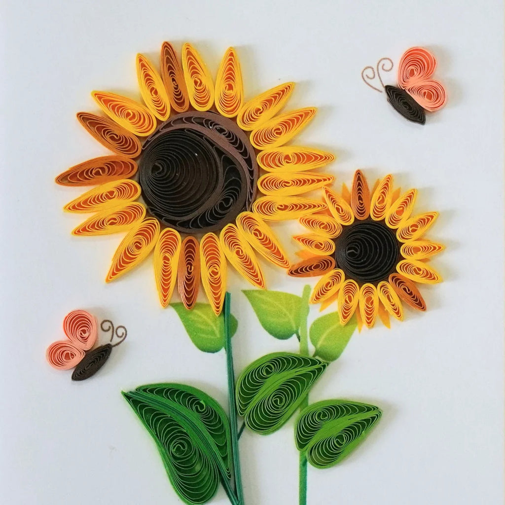 Detail of yellow and orange quilled sunflowers with butterflies and green leaves