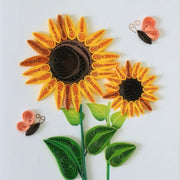 Detail of yellow and orange quilled sunflowers with butterflies and green leaves